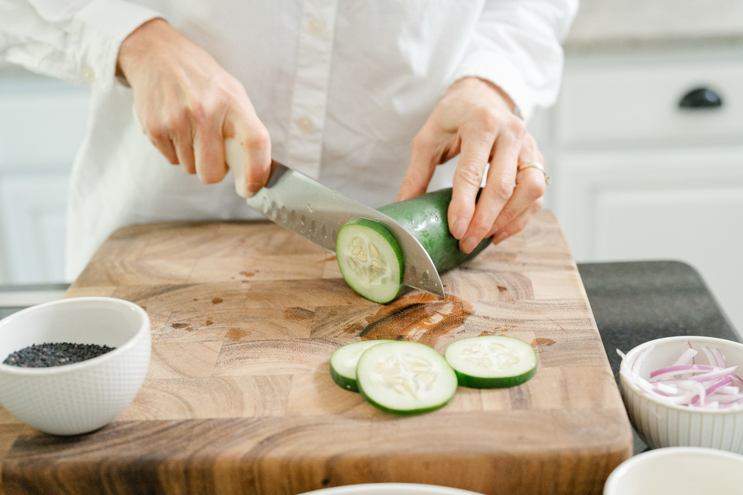 Personal wellness coach cutting cucumber